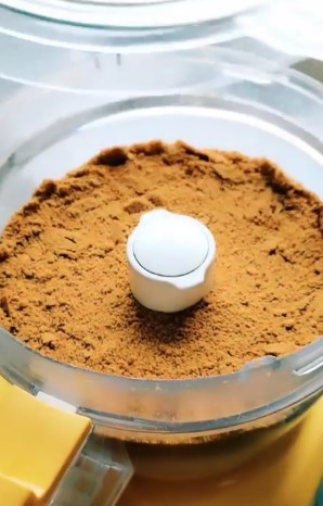 The Best Russian Honey Cake cake crumble in a yellow and white food processer