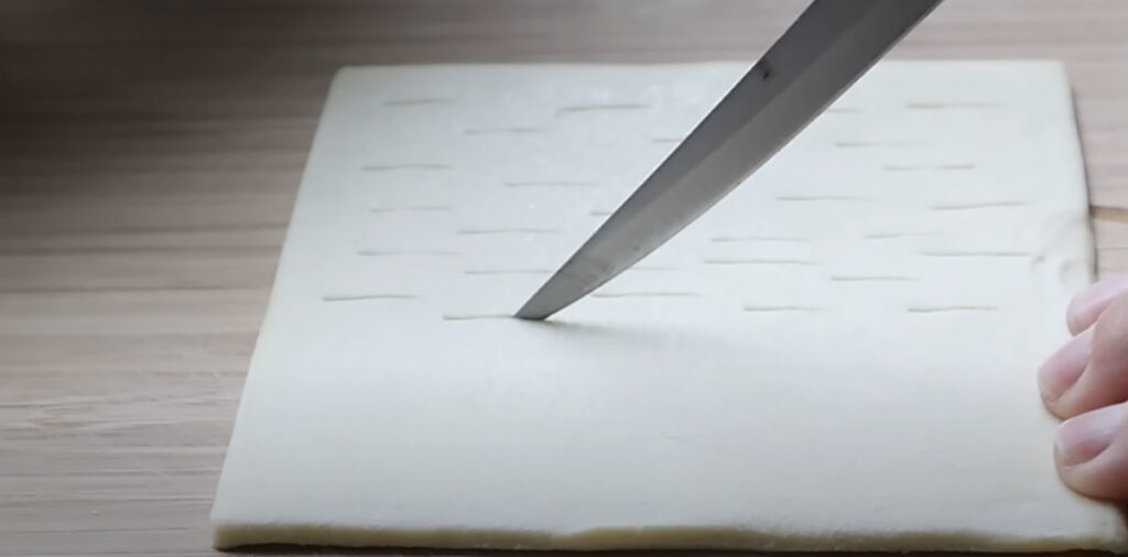 Nutella Walnut Puff Pastry Dessert puff pastry cut with a knife.