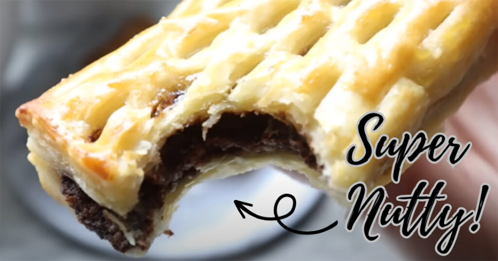 Nutella Walnut Puff Pastry Dessert on a white marble-on a white coutertop with super nutty font with an arrow pointing to pastry.