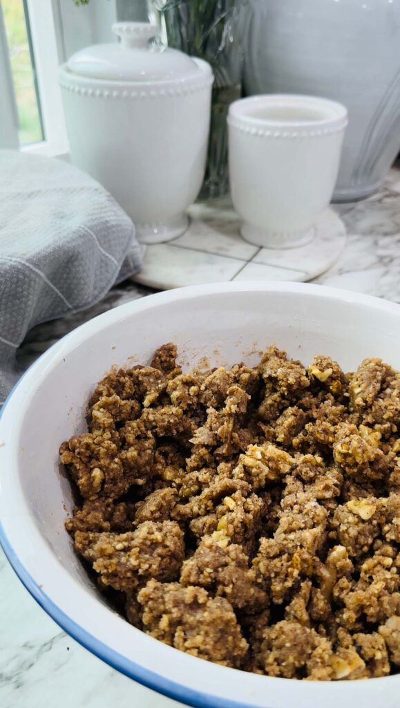 Walnut Roll Pastry - crushed walnuts in a bowl of white canisters on a white granite countertop