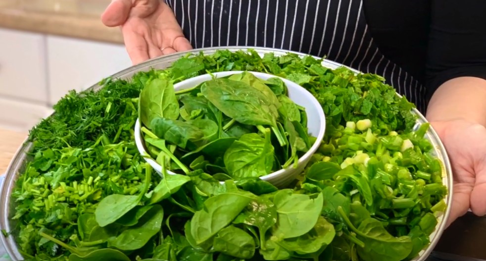 Fresh Greens in a Homemade Flatbread! - Cut mixed fresh greens in a large silver and white platter.