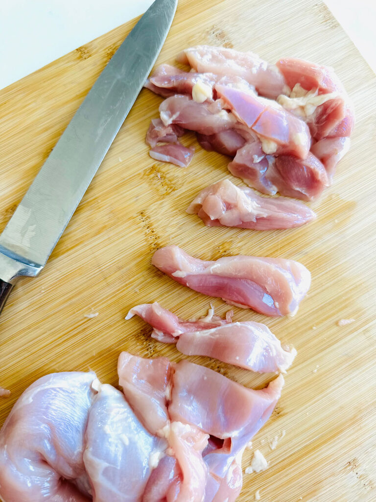 Honey Mustard Chicken with Pinapple Salad w/ Orzo Rice cutting raw chicken.