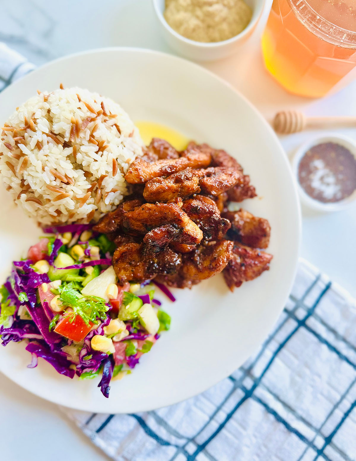 Honey Mustard Chicken with Pinapple Salad w/ Orzo Rice on a white plate