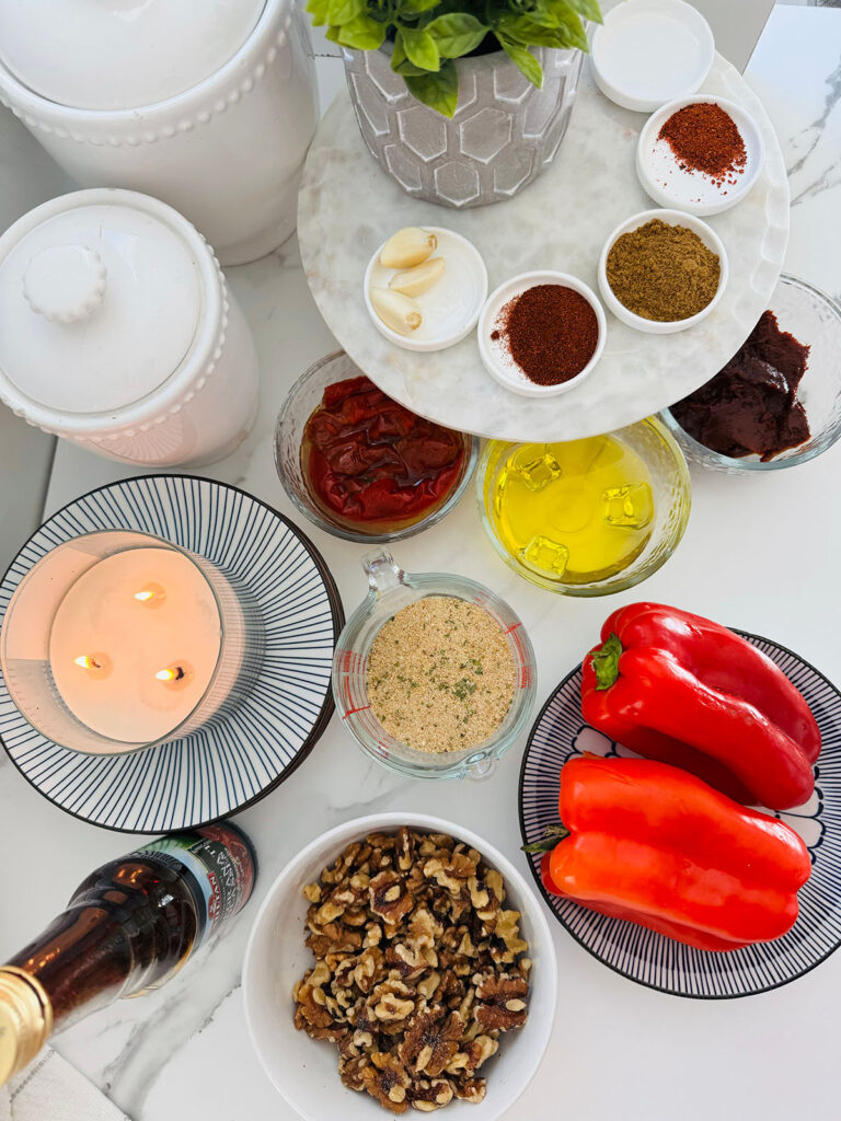 Ingredients red pepers, walnuts, seasonings, oil, pepper paste, lit candle with white canisters 