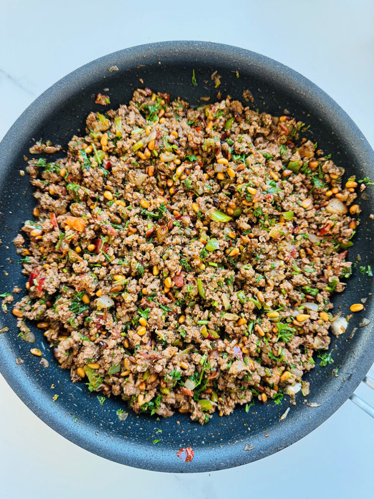 Mediterranean Meat & Cheese Savory Rolls - Cooked meat mixture in a frying pan