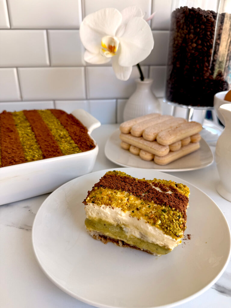 Pistachio Tiramisu Cake – This rich and creamy dessert is made with sweetened pistachio cream and fluffy mascarpone cream, layered to perfection. Finished with a delicate dusting of cocoa powder and crushed pistachios on top.